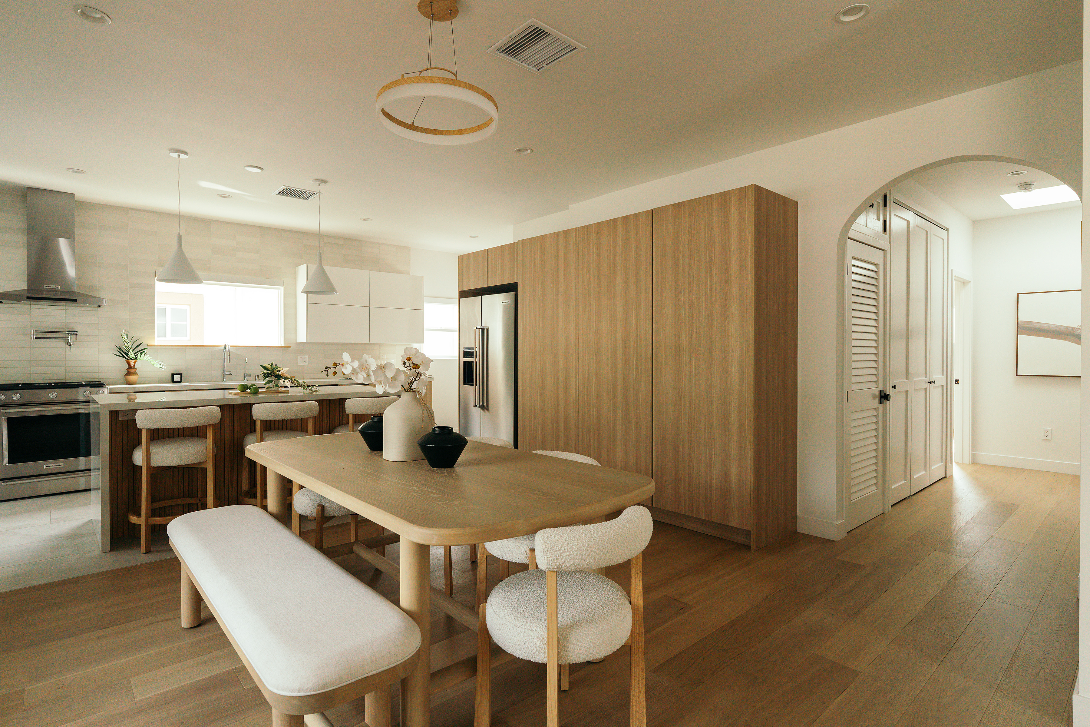 Angled view of the kitchen cabinetry and dining table in West Hollywood