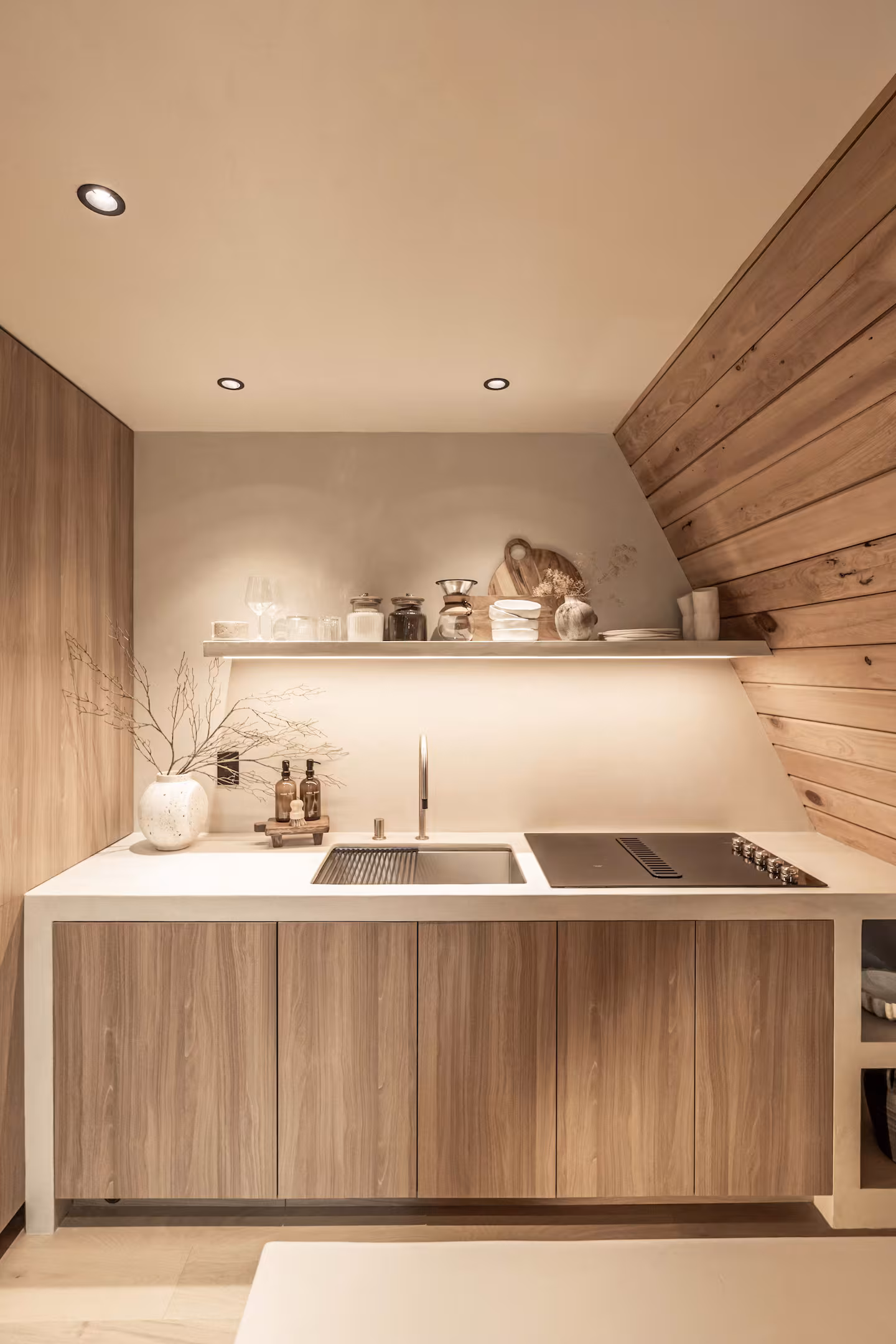 Portrait view of the wood cabinetry, sink, and cooktop in the Silver Lake kitchen