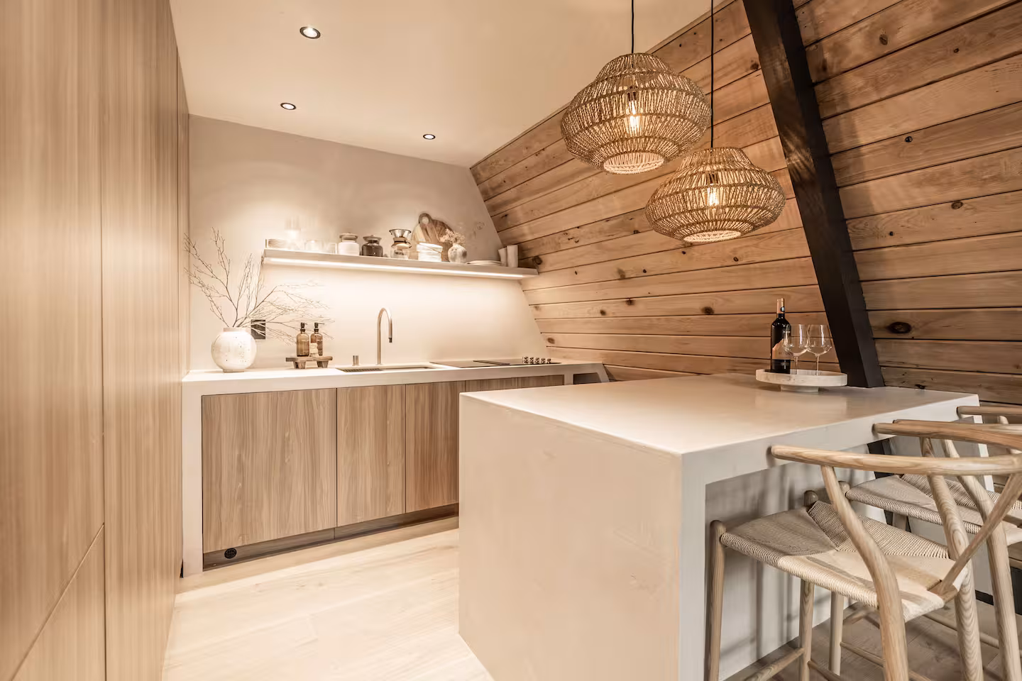 Warm wood kitchen with a white island and woven pendant lights in Silver Lake