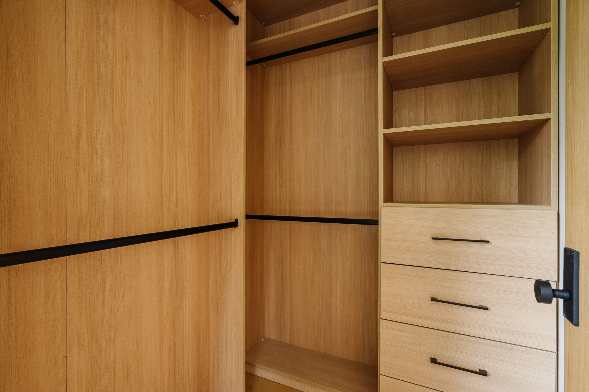 Custom light oak closet drawers, shelves, and hanging rails